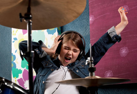 Girl listening to headphone with drumsの写真素材