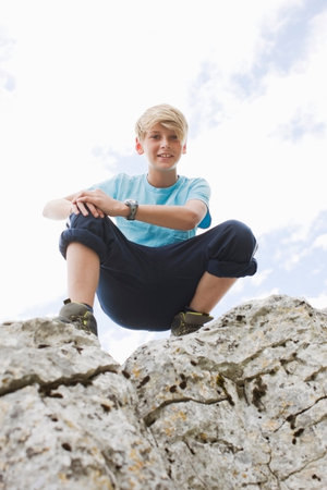 Boy on a rockの写真素材