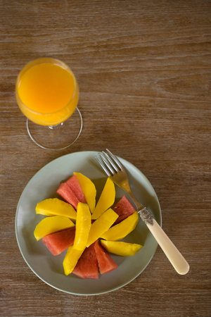 Fruit plate with a glass of orange juiceの写真素材