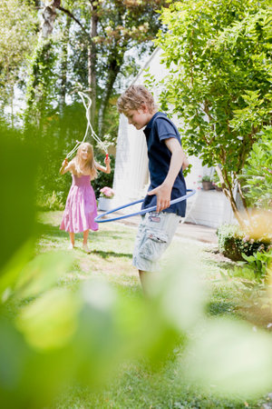Two kids doing sport in a gardenの写真素材