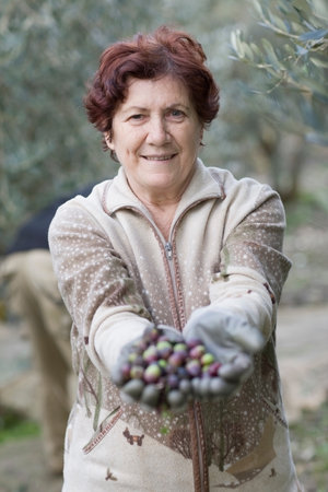 Older woman with olivesの写真素材