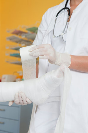 Close up of hands applying a dressingの写真素材