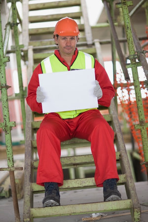 Worker holding an empty sheet of paperの写真素材