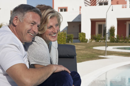 Mature couple relaxing by poolの写真素材