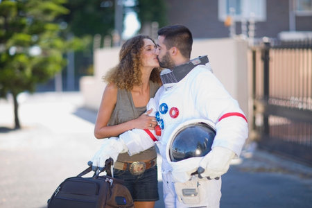 Woman kissing an astronautの写真素材