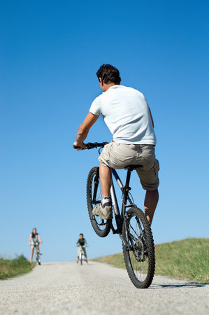 Father with family doing a wheelieの写真素材