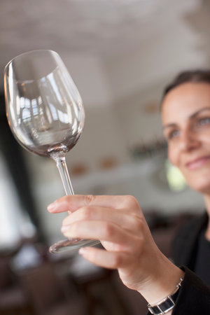Woman cleaning wine glassの写真素材