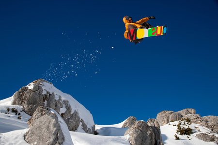 Snowboarder dangerous free ride jumpの写真素材