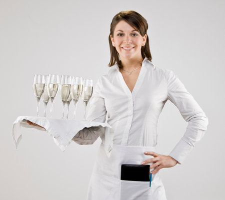 Server carrying tray of champagne flutesの写真素材