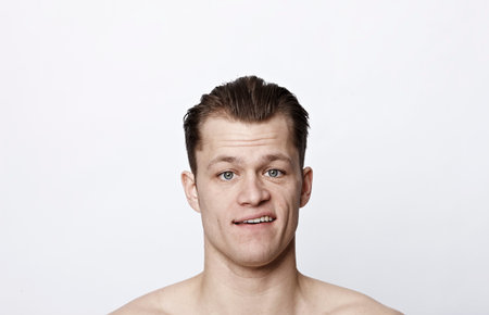 Nude man with confused expression