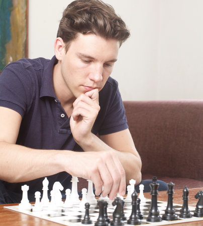 Thoughtful man playing chessの写真素材