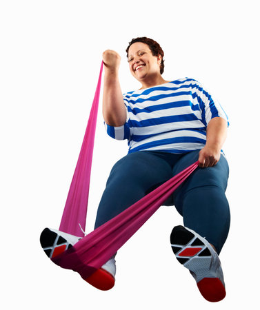 Large woman using resistance bandの写真素材