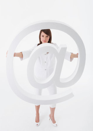 Woman holding large ?@? symbolの写真素材