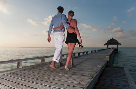 Couple walking together on dockの写真素材
