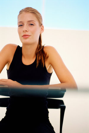 Woman sitting at glass deskの写真素材