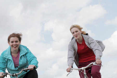 Girls riding bikes outdoorsの写真素材