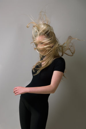 Teenage girl?s hair blowing in windの写真素材