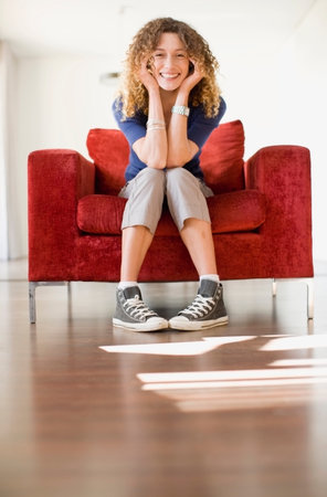 Woman sitting in armchairの写真素材