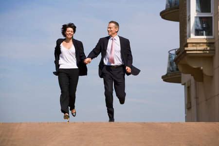 Business people running on streetの写真素材