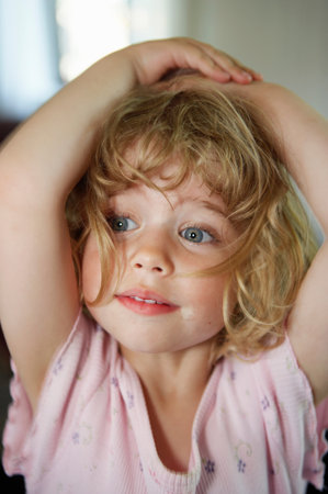 Close up of toddler holding her headの写真素材