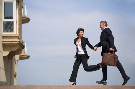 Business people running on streetの写真素材