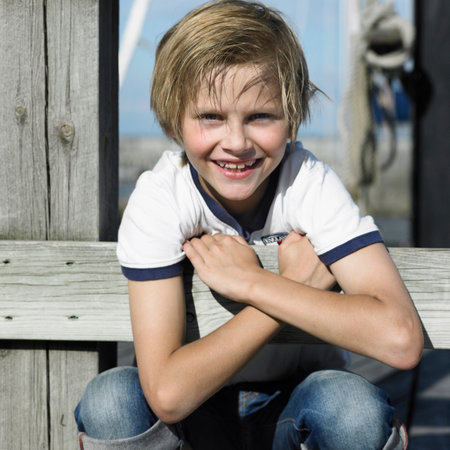 Boy smiling on pierの写真素材