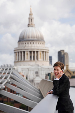 Businesswoman on cell phone outdoorsの写真素材