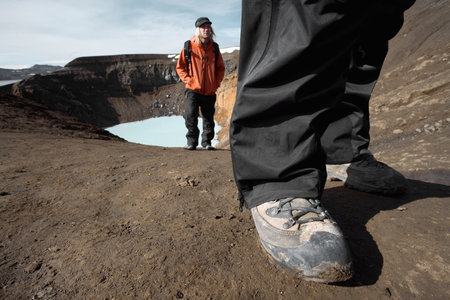 Hikers walking up from crater lakeの写真素材