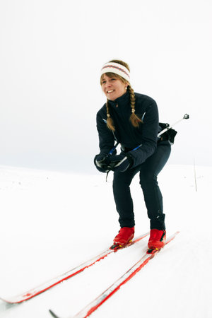 Woman crouching and cross-country skiingの写真素材