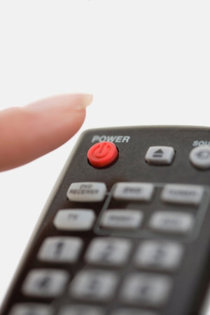 Close up of woman using remote controlの写真素材
