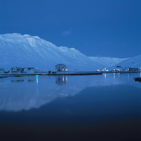 Mountain town reflected in still lakeの写真素材