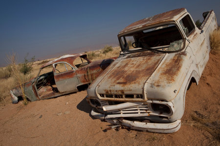 Rusting cars submerged in sandの写真素材