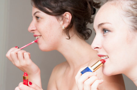 Teenage girls applying makeupの写真素材