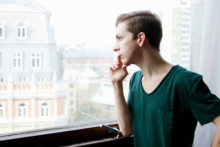 Man looking out windowの写真素材