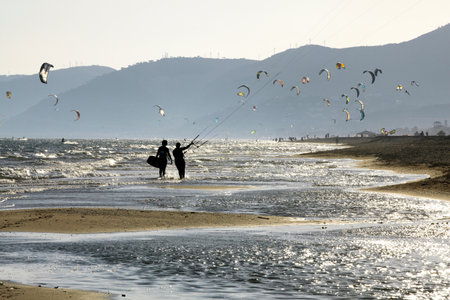 Couple flying kites on beachの写真素材