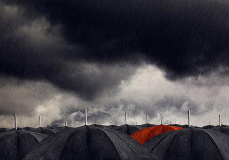 Red umbrella with black umbrellasの写真素材