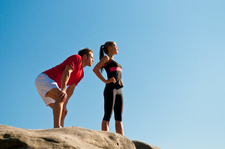 Rock climbers standing on boulderの写真素材