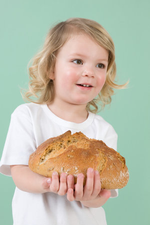 Girl with loaf of breadの写真素材
