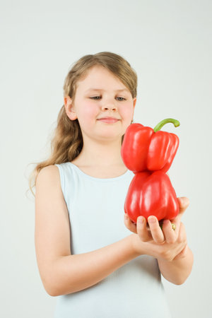 Girl balancing peppersの写真素材