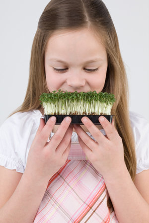 Girl with tray of cressの写真素材