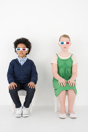 Boy and girl in 3D glassesの写真素材