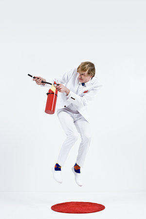 A businessman using a fire extinguisherの写真素材
