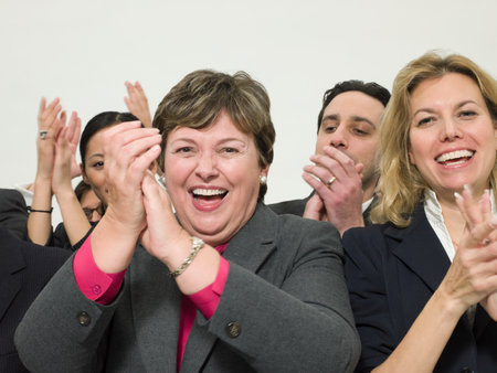 Business women clapping