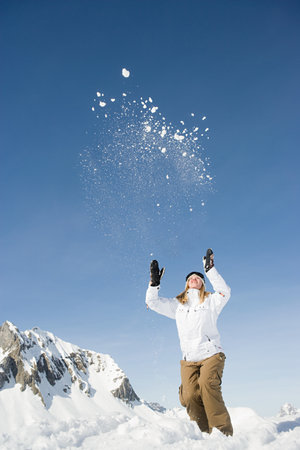 A woman throwing snowの写真素材