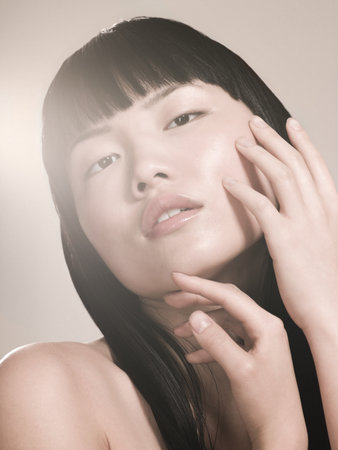 Woman touching her faceの写真素材