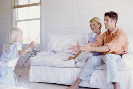 Parents playing with daughterの写真素材