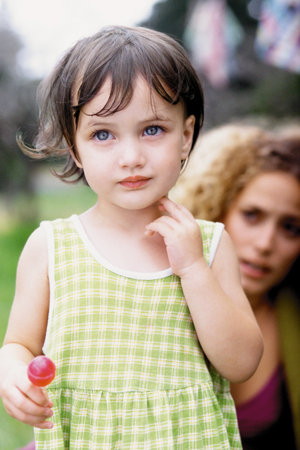 Little girl with mother in the backgroundの写真素材
