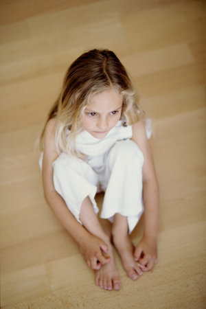 Girl seated on the floorの写真素材
