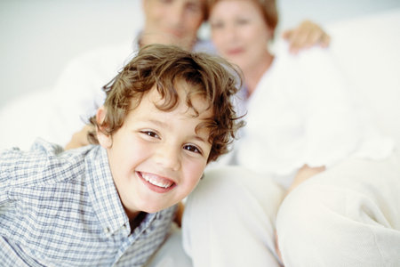 Smiley boy with grandparentsの写真素材
