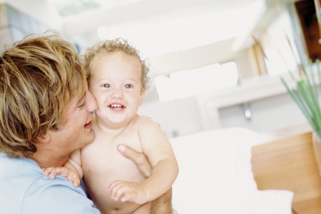 Father and baby having funの写真素材